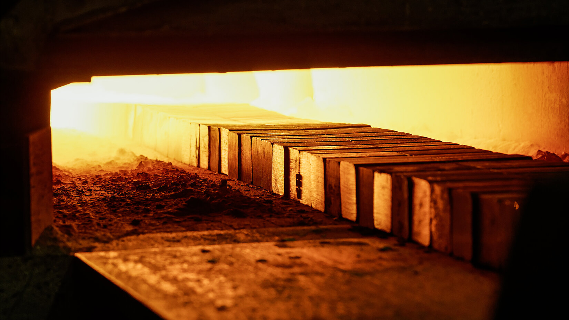 Glühender Ofen mit metallenen Werkstücken während der Wärmebehandlung.